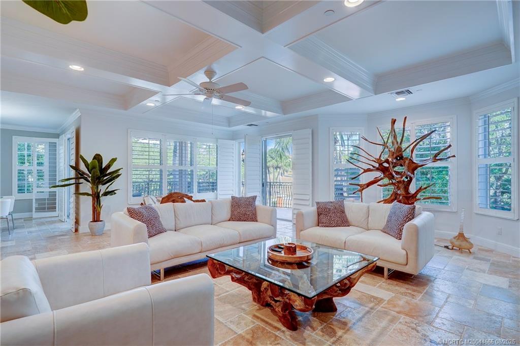 1528 Northeast Outrigger Landings Drive, Unit 208 Jensen Beach, FL 34957 - Photo 26 of 79 a living room with furniture a rug and a chandelier