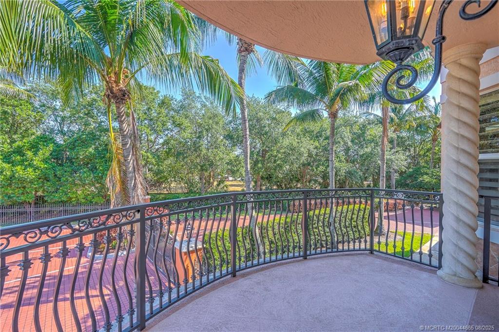 1528 Northeast Outrigger Landings Drive, Unit 208 Jensen Beach, FL 34957 - Photo 29 of 79 a view of a garden with a iron gate