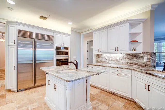 a spacious bedroom with a bed and large windows