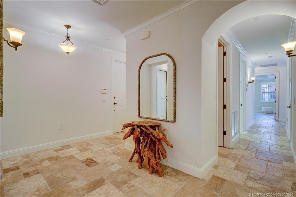 1528 Northeast Outrigger Landings Drive, Unit 208 Jensen Beach, FL 34957 - Photo 36 of 79 a view of a hallway with entryway