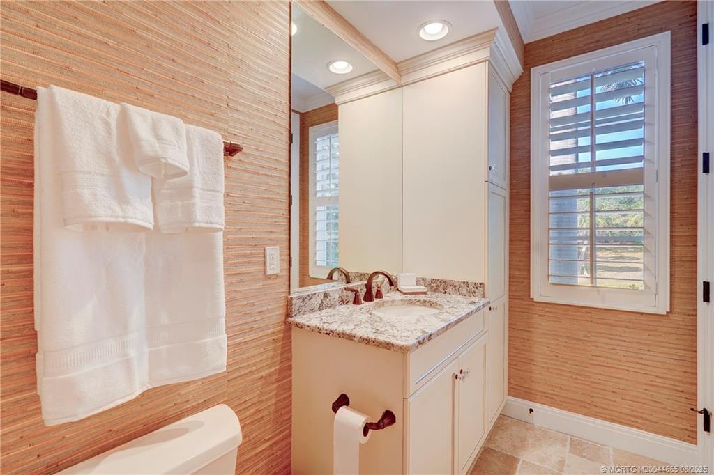 1528 Northeast Outrigger Landings Drive, Unit 208 Jensen Beach, FL 34957 - Photo 37 of 79 a bathroom with a granite countertop sink and a mirror