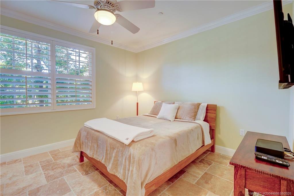 1528 Northeast Outrigger Landings Drive, Unit 208 Jensen Beach, FL 34957 - Photo 40 of 79 a bedroom with a bed and a tv