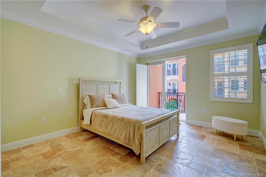 1528 Northeast Outrigger Landings Drive, Unit 208 Jensen Beach, FL 34957 - Photo 43 of 79 a bedroom with a bed and a chandelier