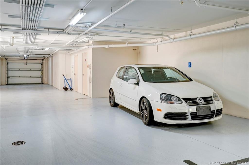 1528 Northeast Outrigger Landings Drive, Unit 208 Jensen Beach, FL 34957 - Photo 6 of 79 a car parked in a garage