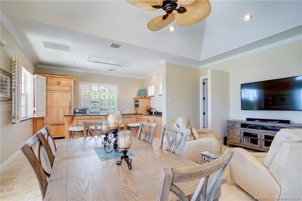 1528 Northeast Outrigger Landings Drive, Unit 208 Jensen Beach, FL 34957 - Photo 68 of 79 a living room with furniture and a flat screen tv