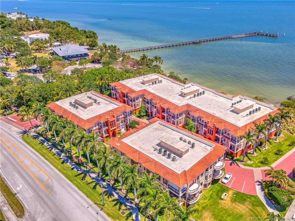 1528 Northeast Outrigger Landings Drive, Unit 208 Jensen Beach, FL 34957 - Photo 77 of 79 an aerial view of a residential houses with outdoor space and street view