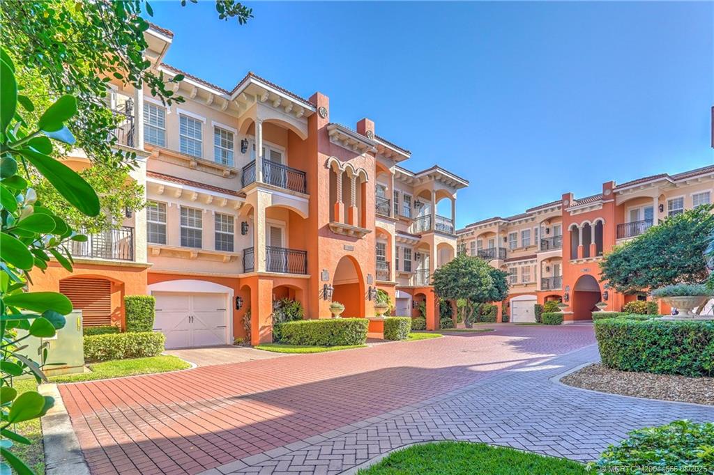 1528 Northeast Outrigger Landings Drive, Unit 208 Jensen Beach, FL 34957 - Photo 9 of 79 a view of a building with a yard