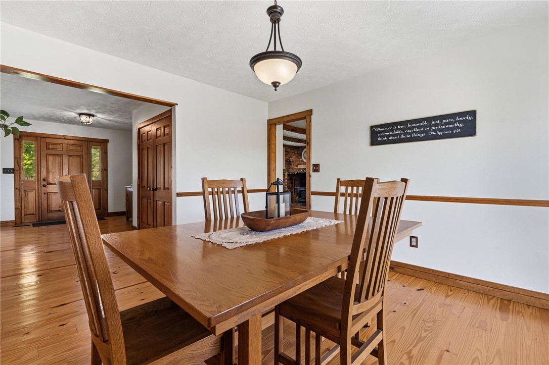 4971 Lackey Road Cedarville, OH 45314 - Photo 30 of 79 This inviting dining area features warm hardwood flooring, creating a comfortable space for gatherings.