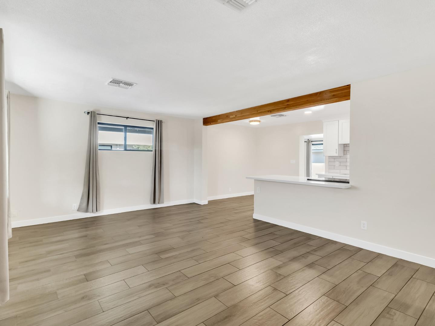 544 West 17th Place Tempe, AZ 85281 - Photo 3 of 38 a view of an empty room with wooden floor and a window
