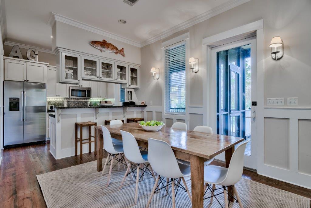 309 Defuniak Street Santa Rosa Beach, FL 32459 - Photo 15 of 53 a view of a dining room with furniture and wooden floor
