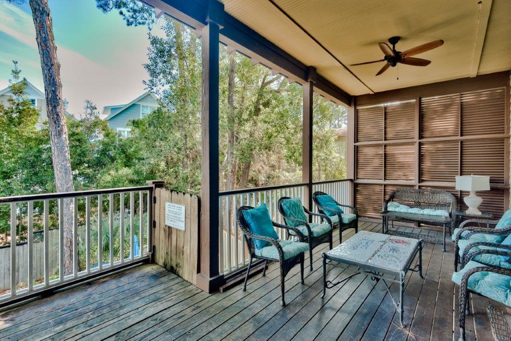 309 Defuniak Street Santa Rosa Beach, FL 32459 - Photo 17 of 53 a balcony with wooden floor and outdoor seating