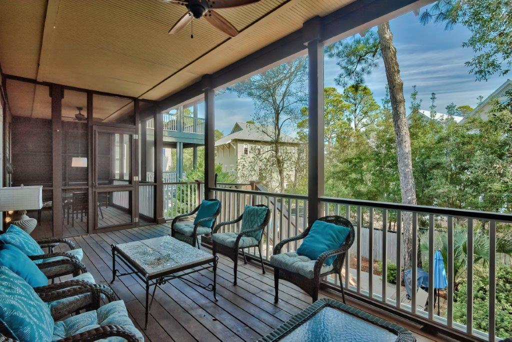 309 Defuniak Street Santa Rosa Beach, FL 32459 - Photo 19 of 53 a balcony with wooden floor and outdoor seating
