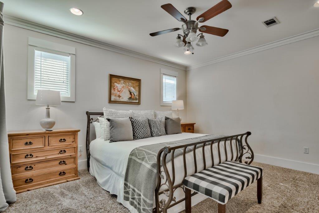 309 Defuniak Street Santa Rosa Beach, FL 32459 - Photo 30 of 53 a bedroom with a bed and a chandelier