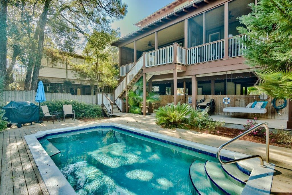 309 Defuniak Street Santa Rosa Beach, FL 32459 - Photo 3 of 53 a view of house with swimming pool outdoor seating and plants