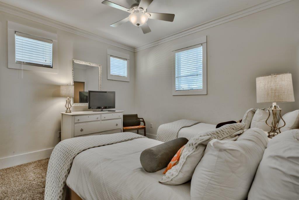 309 Defuniak Street Santa Rosa Beach, FL 32459 - Photo 36 of 53 a bedroom with a bed and flat screen tv