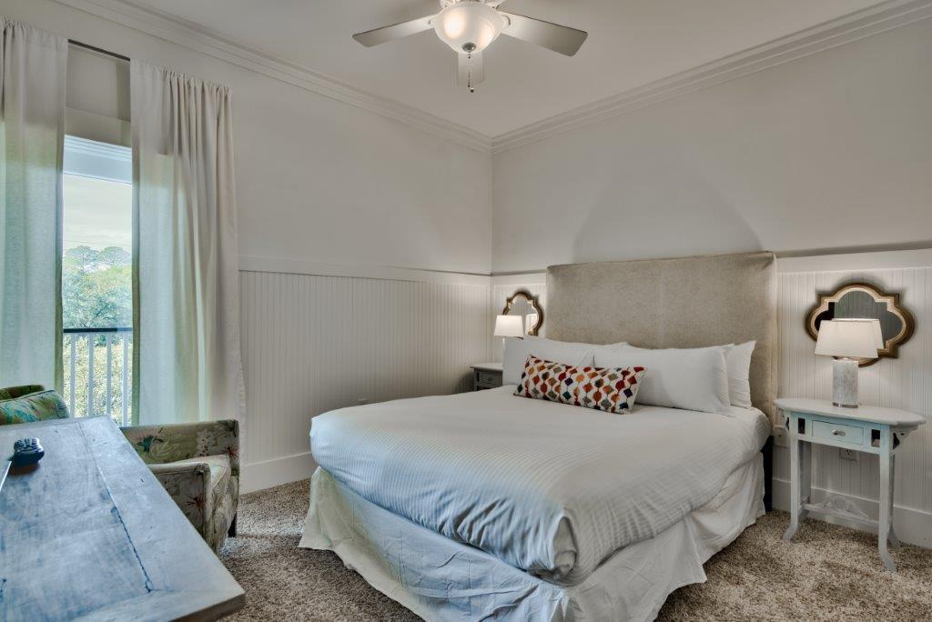 309 Defuniak Street Santa Rosa Beach, FL 32459 - Photo 38 of 53 a bedroom with a bed and a chandelier