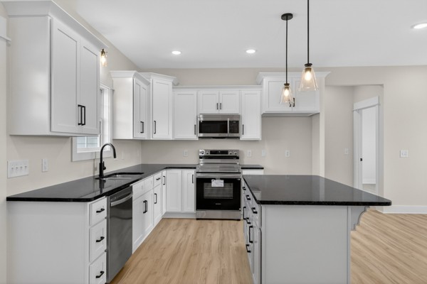 1233 Coleytown Road Lafayette, TN 37083 - Photo 12 of 39 a kitchen with stainless steel appliances a stove sink microwave and cabinets
