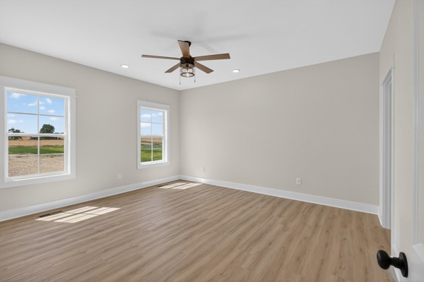 1233 Coleytown Road Lafayette, TN 37083 - Photo 16 of 39 an empty room with wooden floor fan and windows