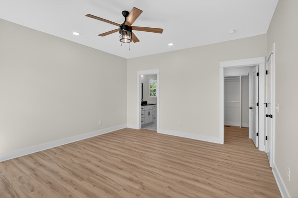1233 Coleytown Road Lafayette, TN 37083 - Photo 19 of 39 a view of a big room with wooden floor and a ceiling fan