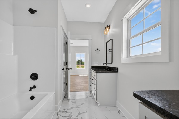 1233 Coleytown Road Lafayette, TN 37083 - Photo 23 of 39 a bathroom with a granite countertop sink a mirror and shower