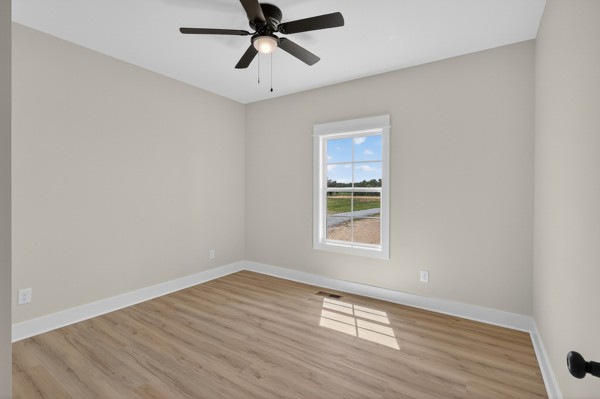 1233 Coleytown Road Lafayette, TN 37083 - Photo 25 of 39 an empty room with wooden floor fan and windows