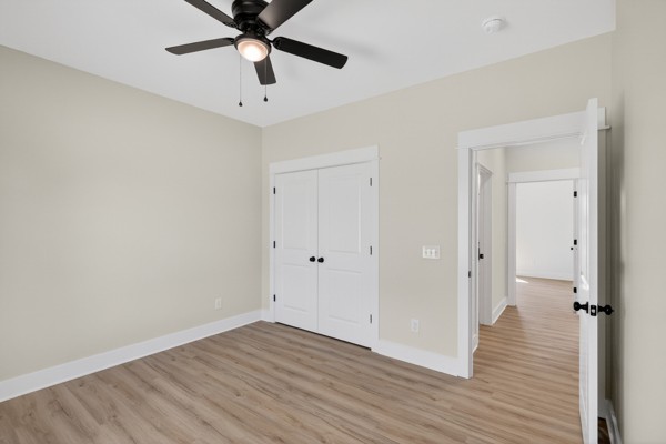 1233 Coleytown Road Lafayette, TN 37083 - Photo 28 of 39 a view of a room with wooden floor and a ceiling fan