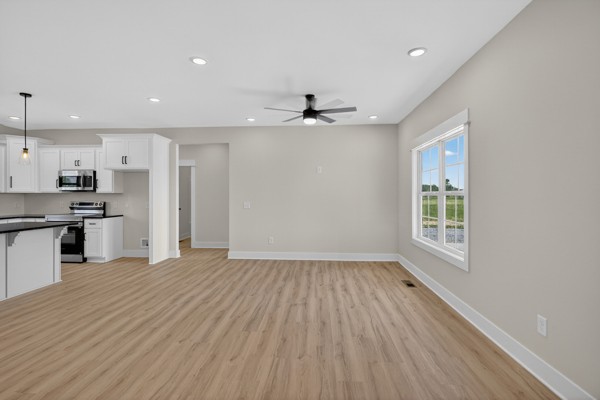 1233 Coleytown Road Lafayette, TN 37083 - Photo 6 of 39 a view of a kitchen with a sink and dishwasher a refrigerator with wooden floor