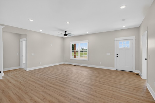 1233 Coleytown Road Lafayette, TN 37083 - Photo 7 of 39 a view of an empty room with wooden floor and a window