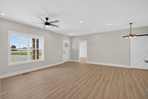 1233 Coleytown Road Lafayette, TN 37083 - Photo 8 of 39 a view of empty room with wooden floor and ceiling fan