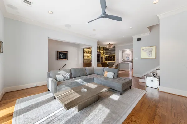 a kitchen with stainless steel appliances a stove top oven a sink a refrigerator and white cabinets