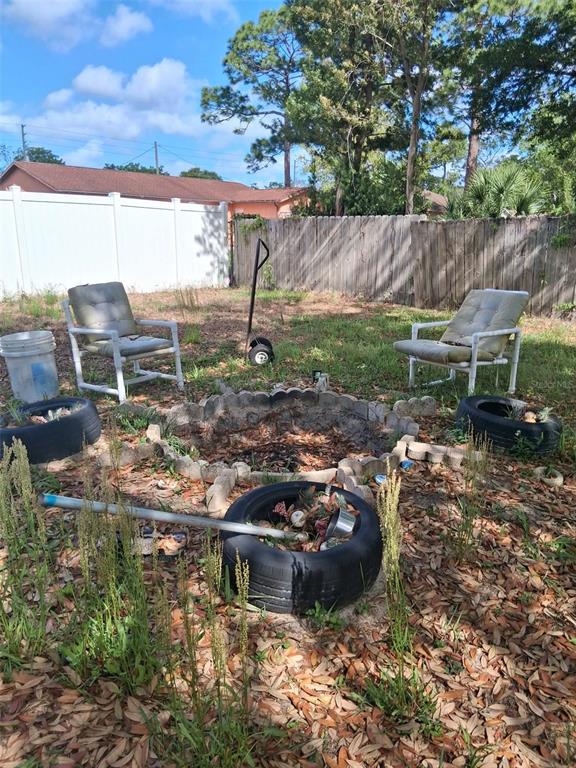 2335 Canfield Drive Spring Hill, FL 34609 - Photo 1 of 1 a view of a fire pit in front of a yard