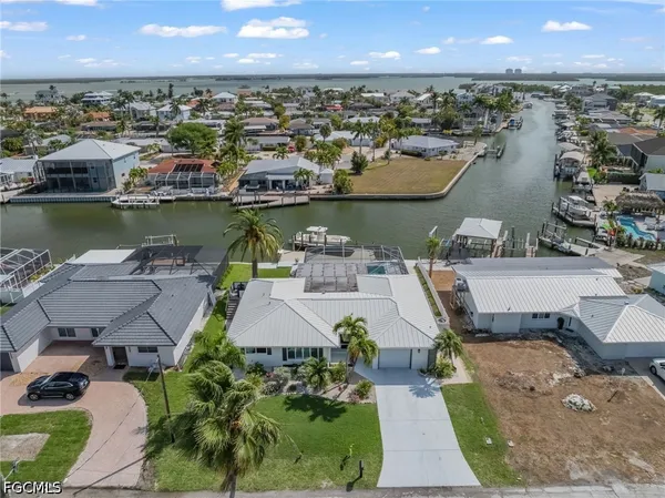 an aerial view of a house with a lake view