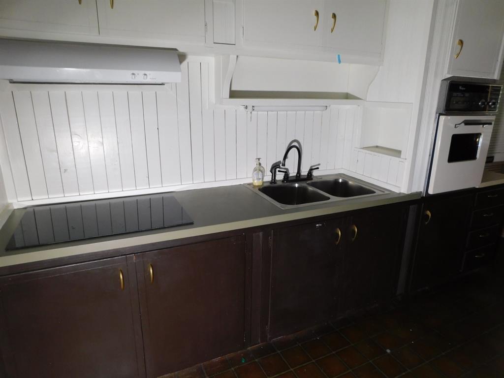 300 South Main Street Springhill, LA 71075 - Photo 35 of 35 a kitchen with a sink and cabinets