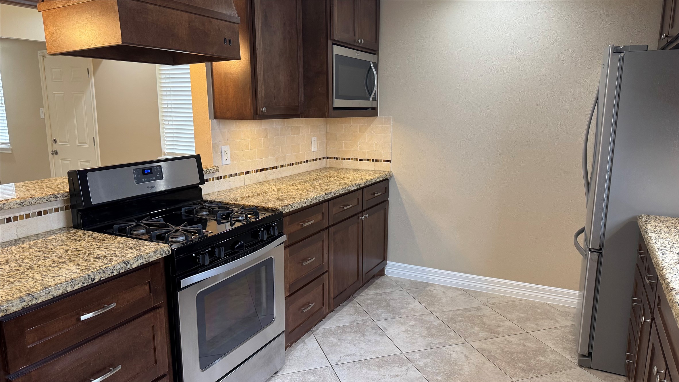 3310 Glen Spring Drive Houston, TX 77339 - Photo 11 of 18 a kitchen with a stove and a refrigerator
