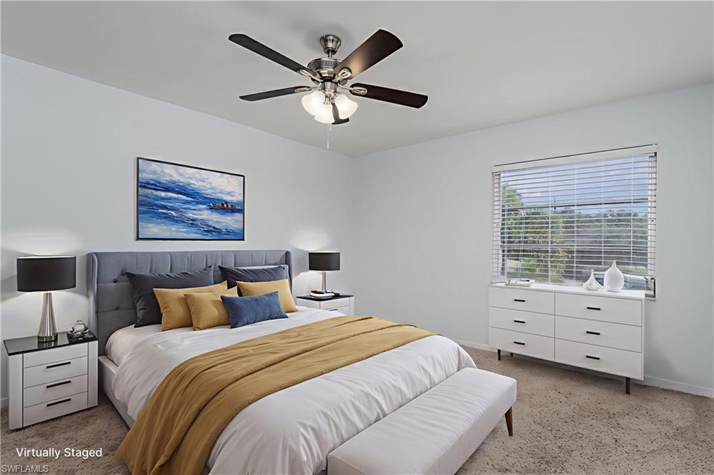 180 Cypress Way East, Unit B212 Naples, FL 34110 - Photo 23 of 40 a bedroom with a bed and a window