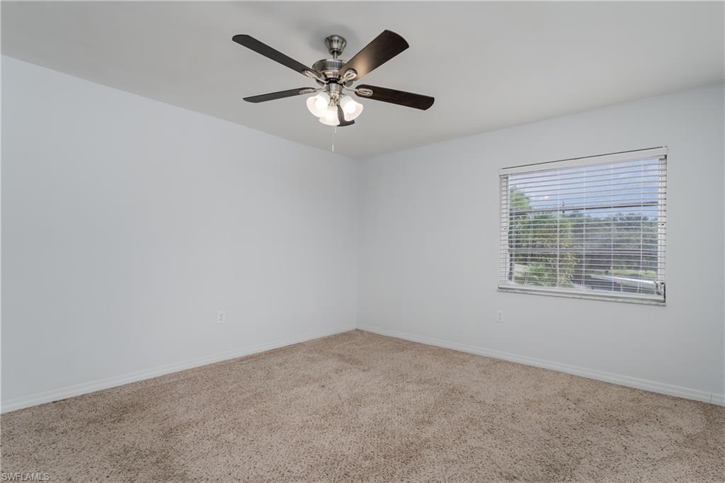 180 Cypress Way East, Unit B212 Naples, FL 34110 - Photo 24 of 40 an empty room with a window