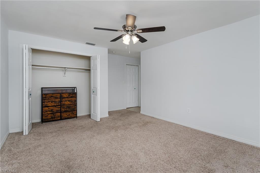 180 Cypress Way East, Unit B212 Naples, FL 34110 - Photo 25 of 40 a view of an empty room and a ceiling fan
