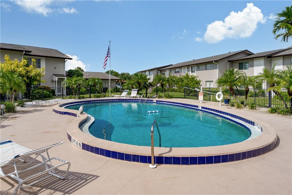 180 Cypress Way East, Unit B212 Naples, FL 34110 - Photo 28 of 40 a view of a swimming pool with a patio