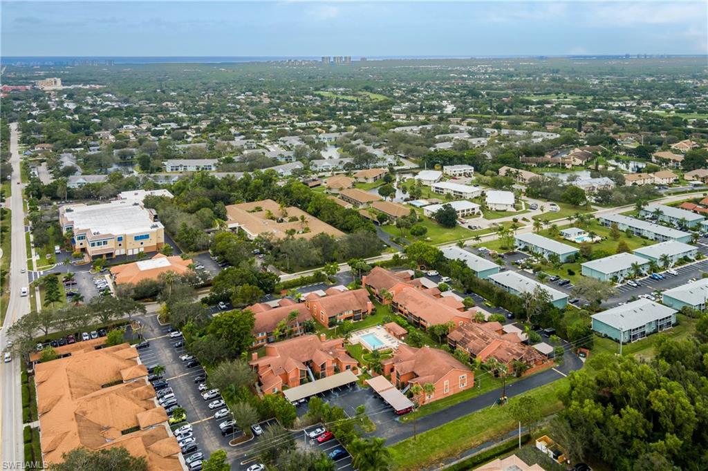 180 Cypress Way East, Unit B212 Naples, FL 34110 - Photo 35 of 40 an aerial view of residential houses with city view