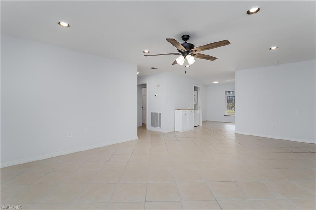 180 Cypress Way East, Unit B212 Naples, FL 34110 - Photo 5 of 40 a view of a livingroom with a ceiling fan and window