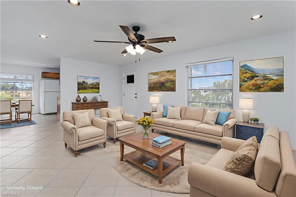180 Cypress Way East, Unit B212 Naples, FL 34110 - Photo 6 of 40 a living room with furniture and a large window