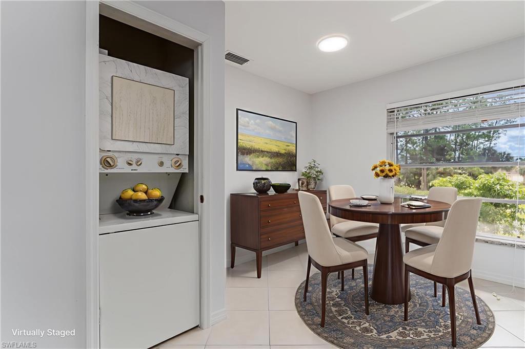 180 Cypress Way East, Unit B212 Naples, FL 34110 - Photo 9 of 40 a dining room with furniture and window