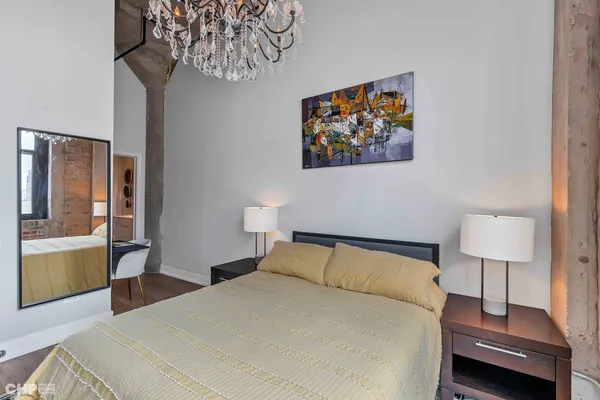 a bedroom with a bed and a lamp on table