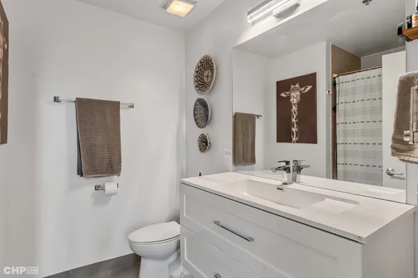 a bathroom with a sink vanity and toilet