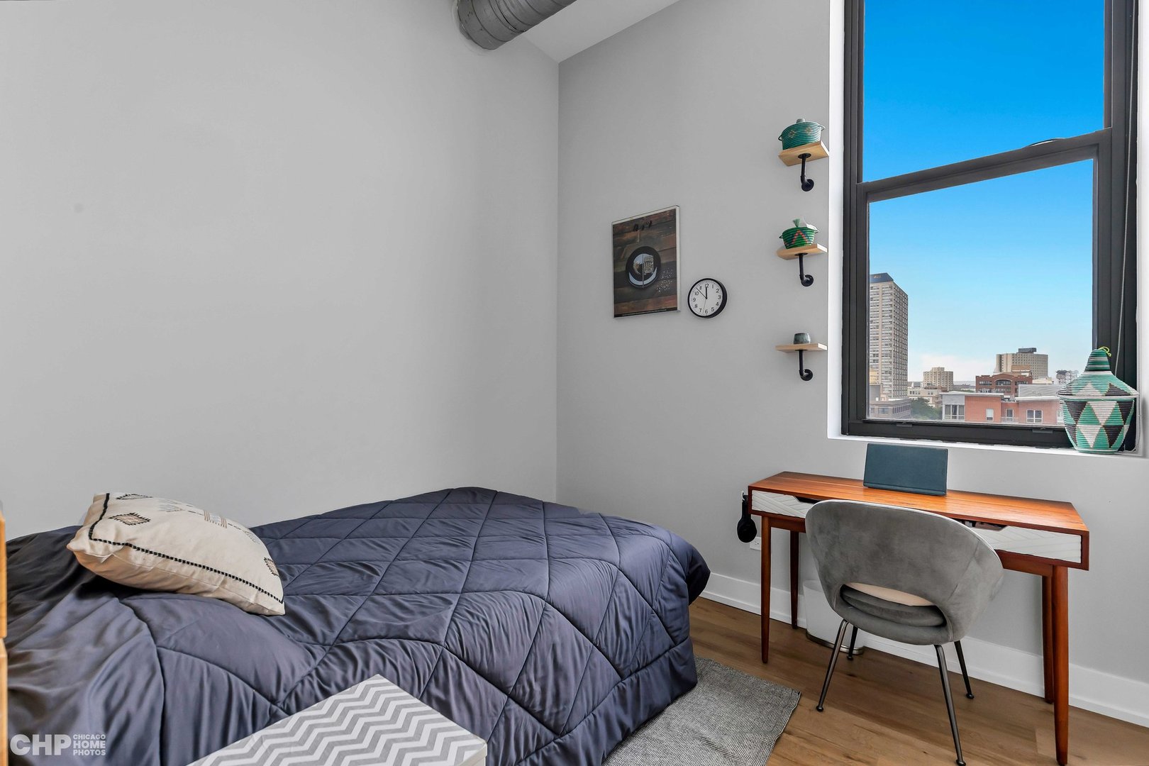 320 East 21st Street, Unit 617 Chicago, IL 60616 - Photo 14 of 23 a bedroom with a bed and a window