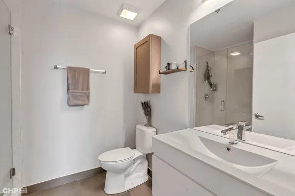 a bathroom with a toilet sink vanity and mirror