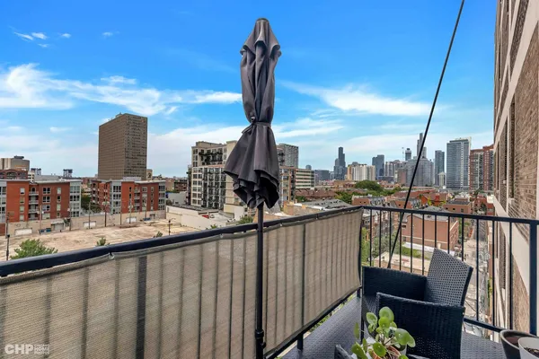 a view of a balcony with two chairs and a wooden fence