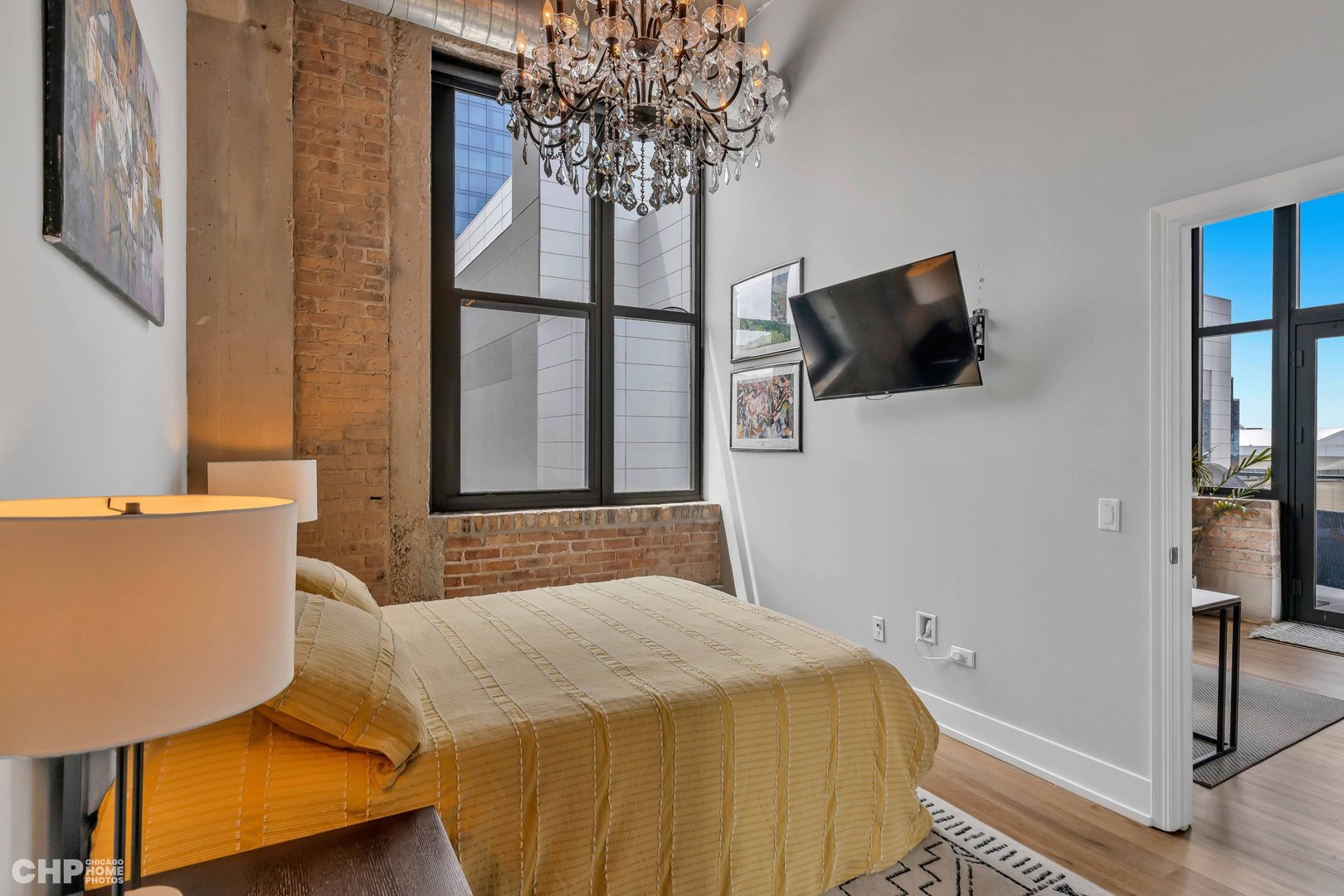 320 East 21st Street, Unit 617 Chicago, IL 60616 - Photo 10 of 23 a bedroom with a bed and a window