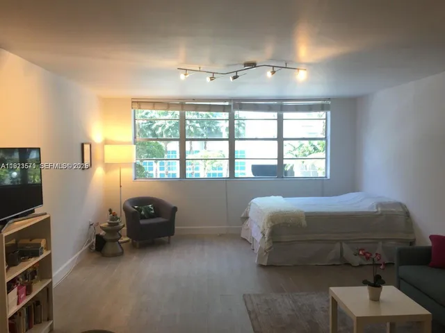 a bedroom with a bed and a tv