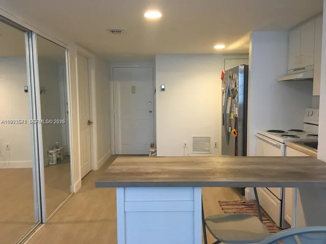 a kitchen with stainless steel appliances granite countertop a refrigerator and a sink